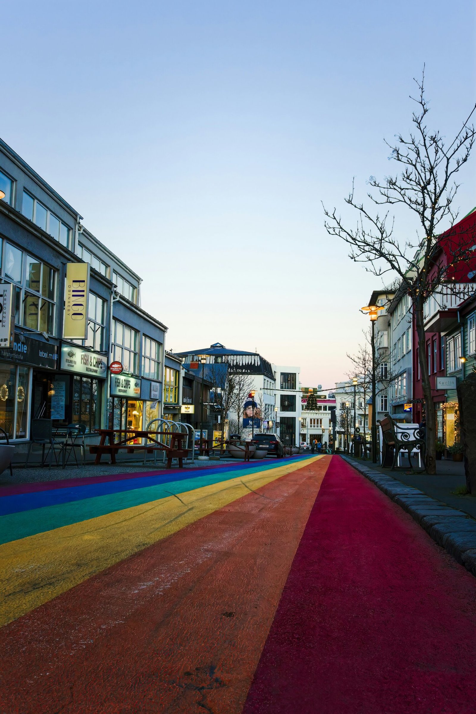 a rainbow painted street in the middle of a city